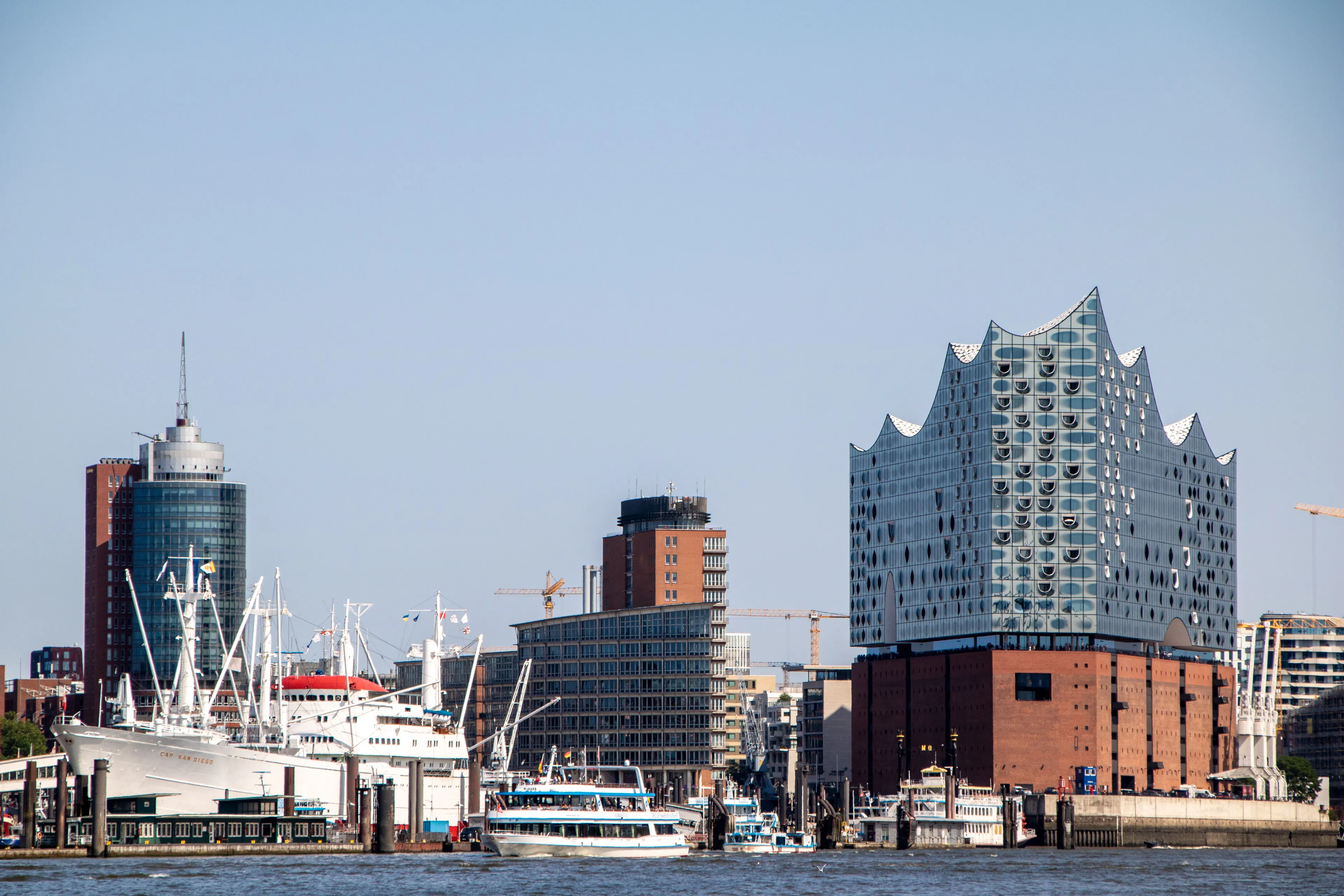 The museum ship Cap San Diego and a harbour ferry on the Elbe, with the Elbphilharmonie and the HafenCity towers behind